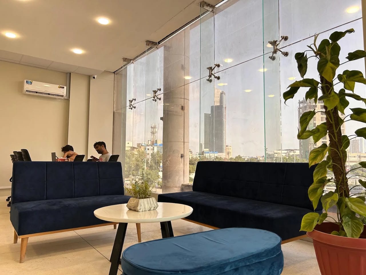 Adsify office lounge with floor-to-ceiling windows overlooking the Karachi skyline